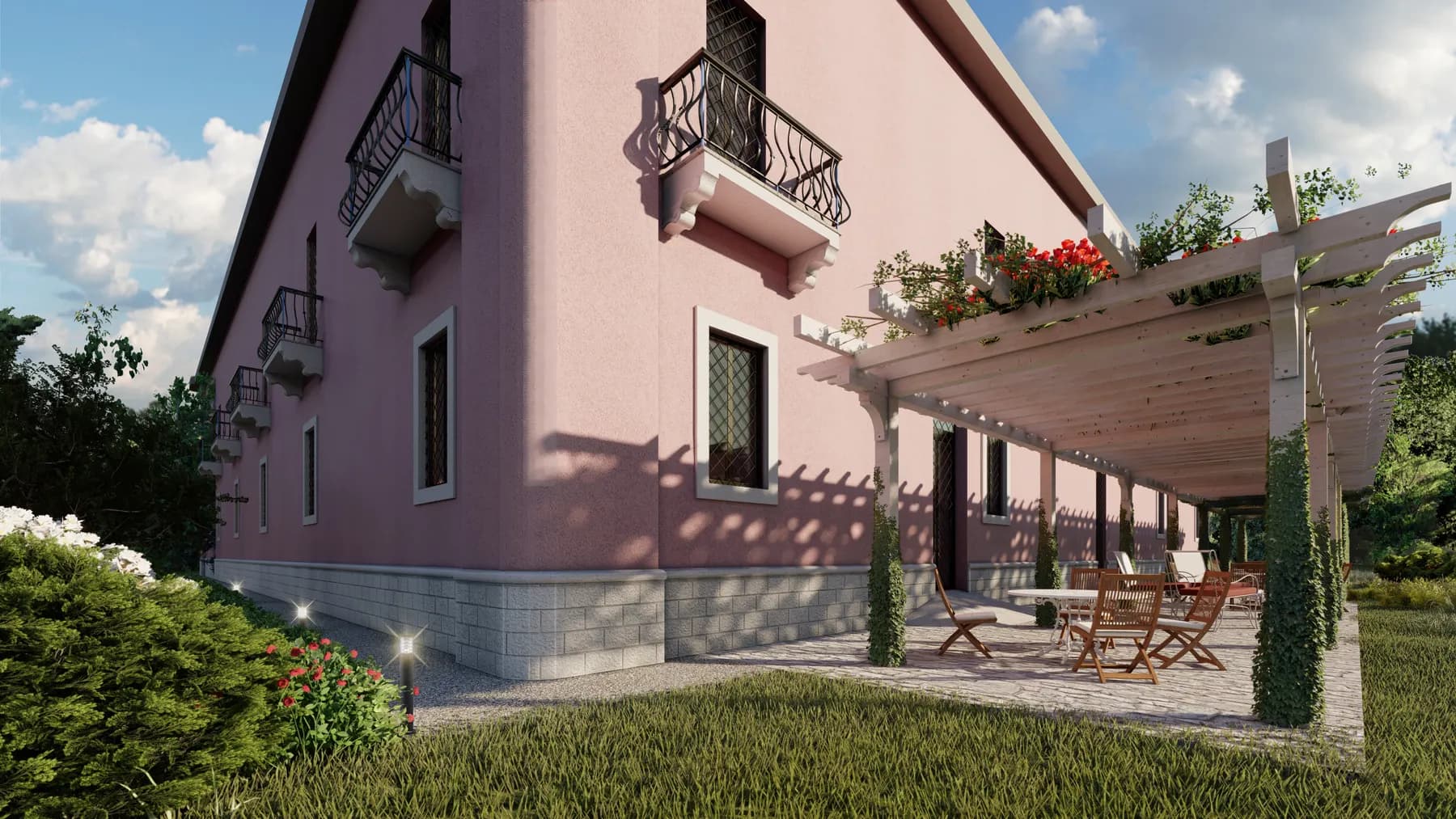 Prospetto del palazzo in rosa antico con la pergola sul fianco e il giardino